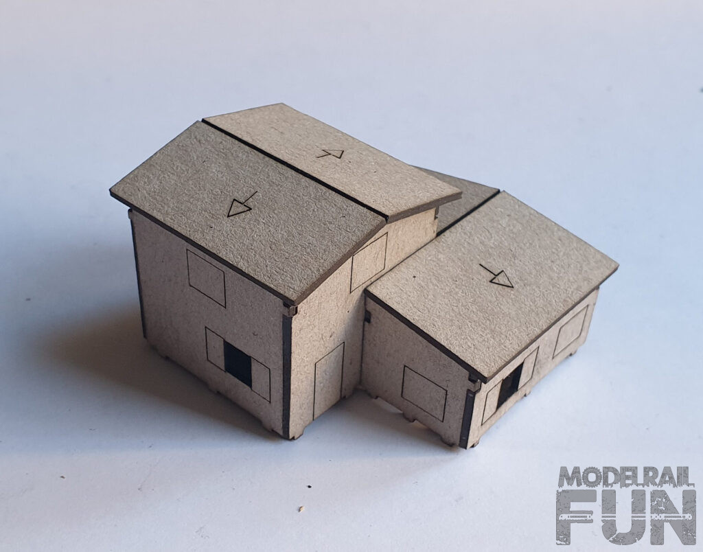 Caserío de cartón cortado. Edificio encolado